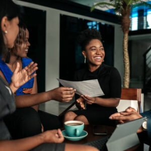 All african casual business meeting. Candid real happy moment between four work colleagues.